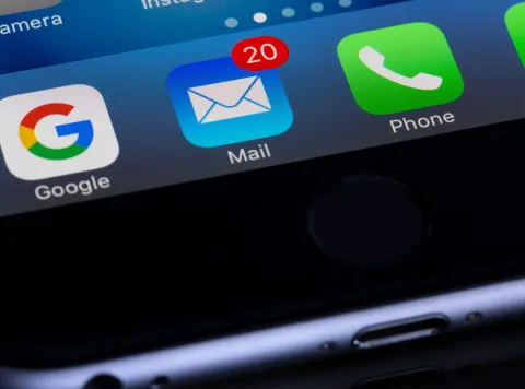 photo of phone with Gmail, Mail, and Phone app icons