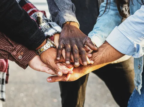 Multiple hands coming together