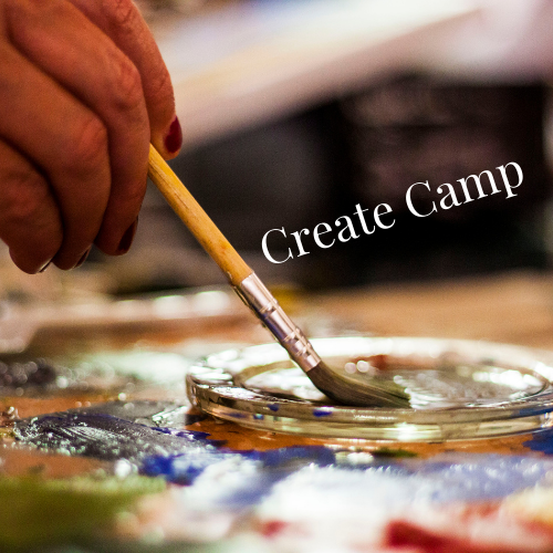 A hand holding a paintbrush