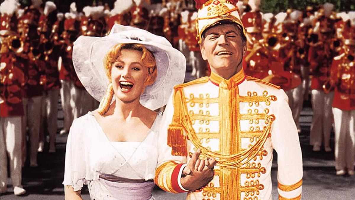 Shirley Jones and Robert Preston in their roles as Marion and Harold, leading a parade.