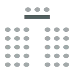 Two rows of chairs with a center aisle facing the front of the room where there is a table and chairs facing the room.